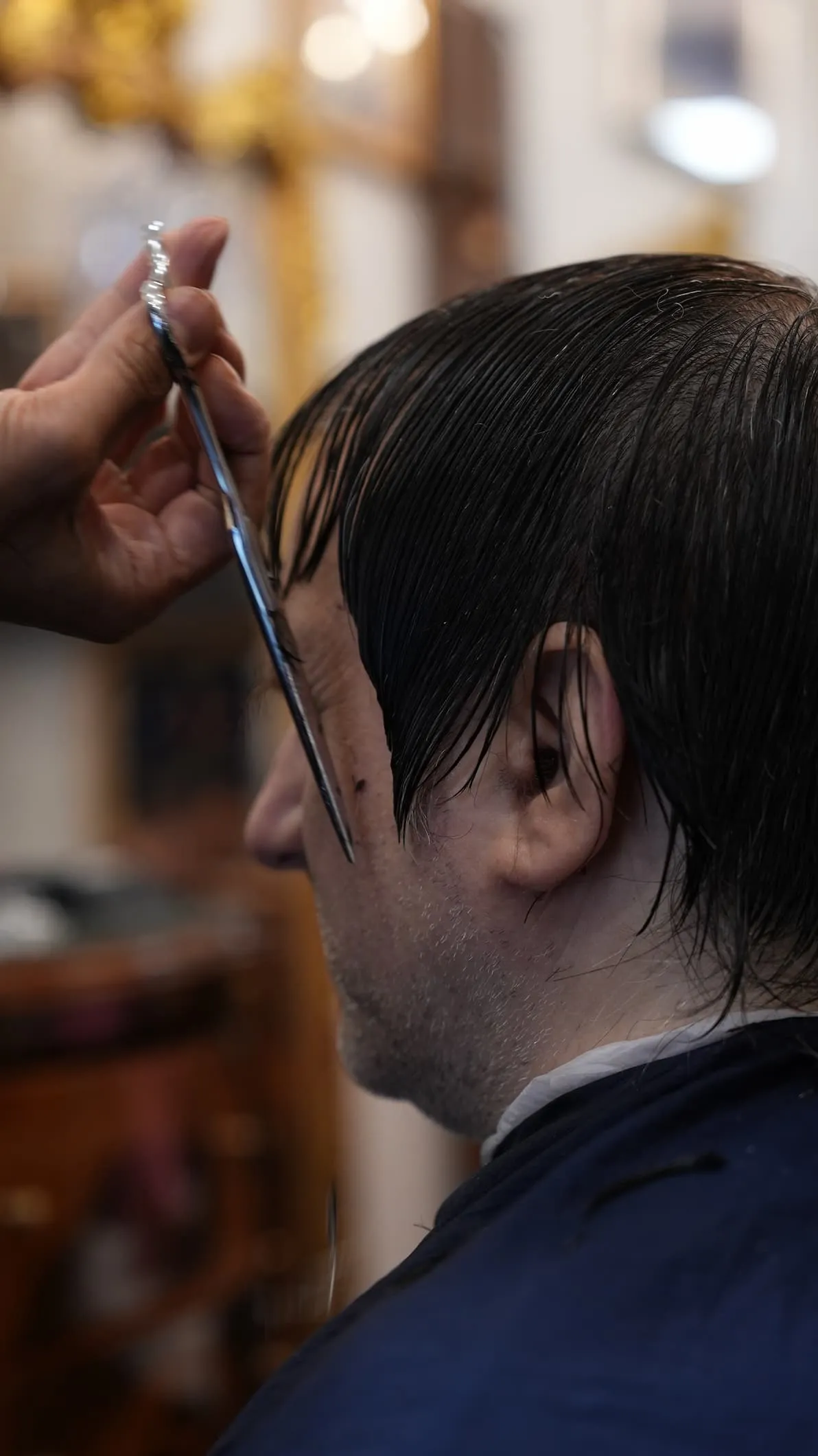 Client receiving a precision scissors cut